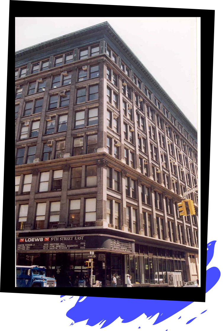 An older photo of the Loews Movie Theater next to the 890 Broadway building shot from across the street, on 19th and Broadway, showcasing its expansive architecture and design.