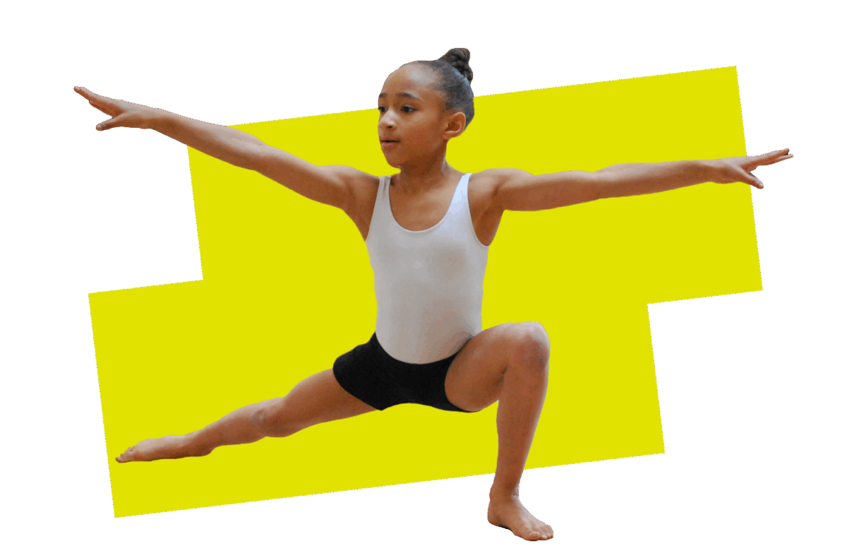 A young dancer in a white leotard and black shorts holds a strong pose in a deep lunge, her arms out to the side and her face in concentration.