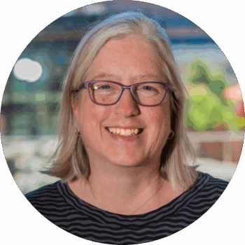 Headshot of Maggie Christ, Executive Director of Ballet Tech, smiling.