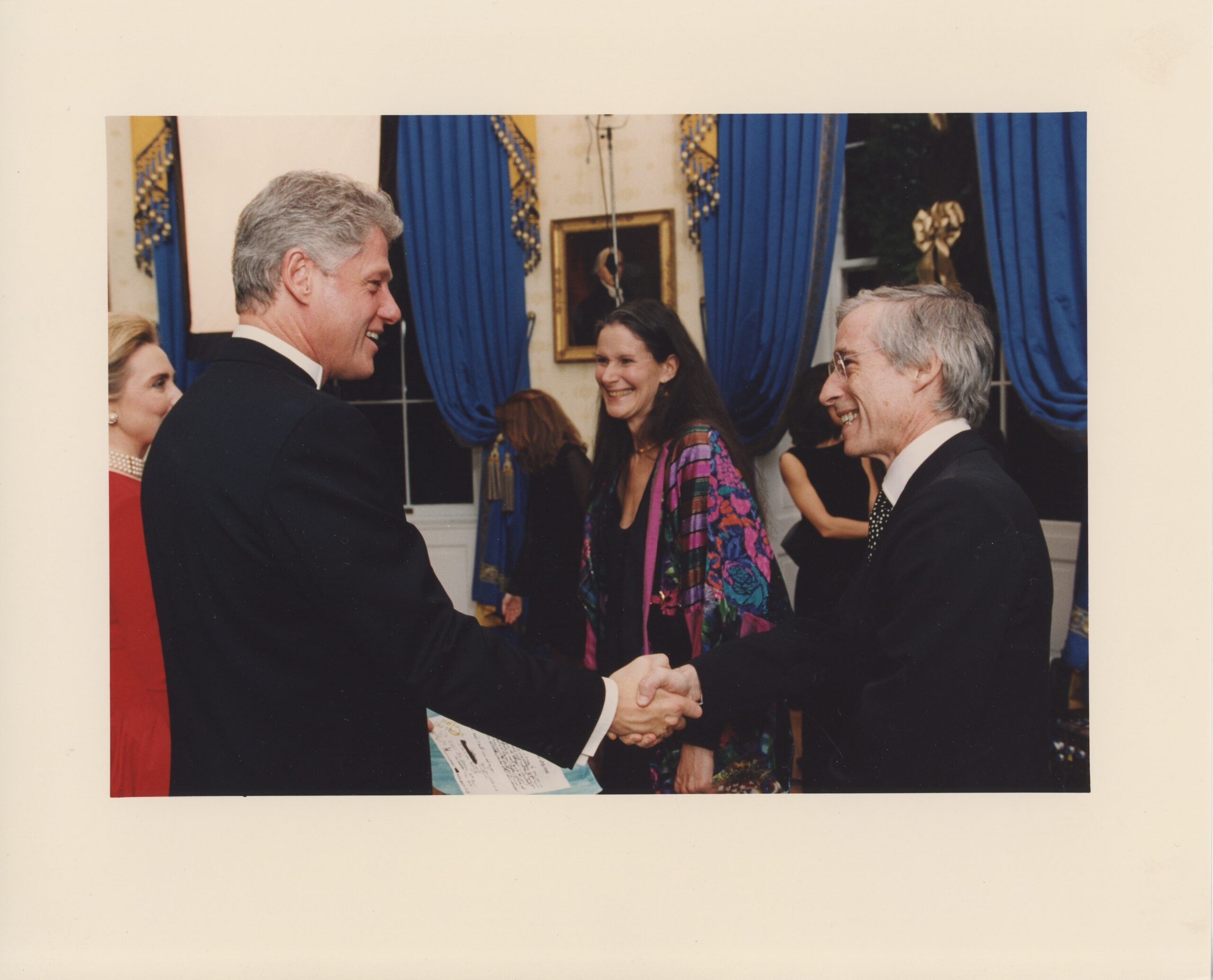 Eliot Feld shakes hands with Bill Clinton in the White House, with Hillary Clinton and Judith Friedlander in the background.
