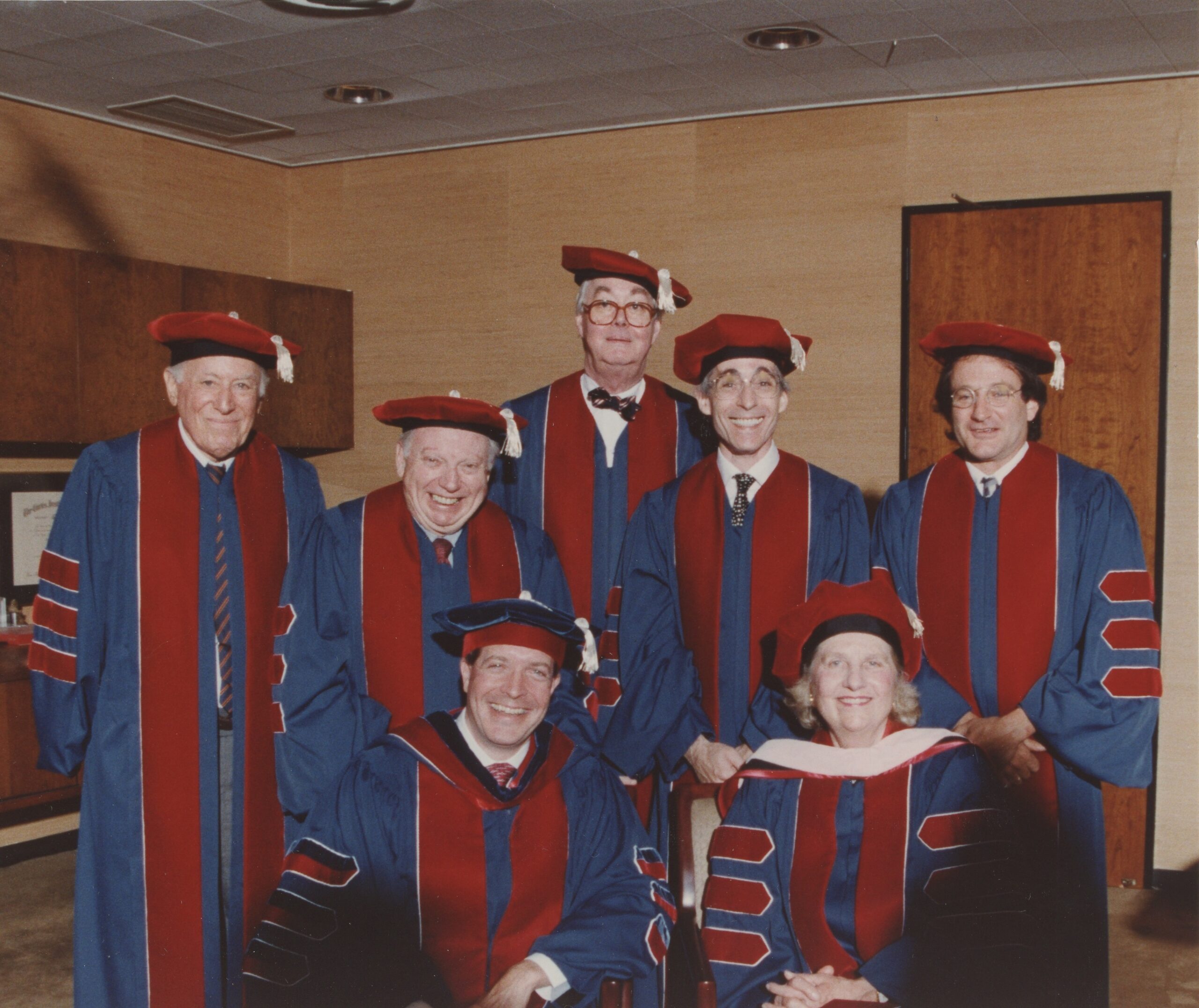 Eliot Feld and others pose in graduation robes.