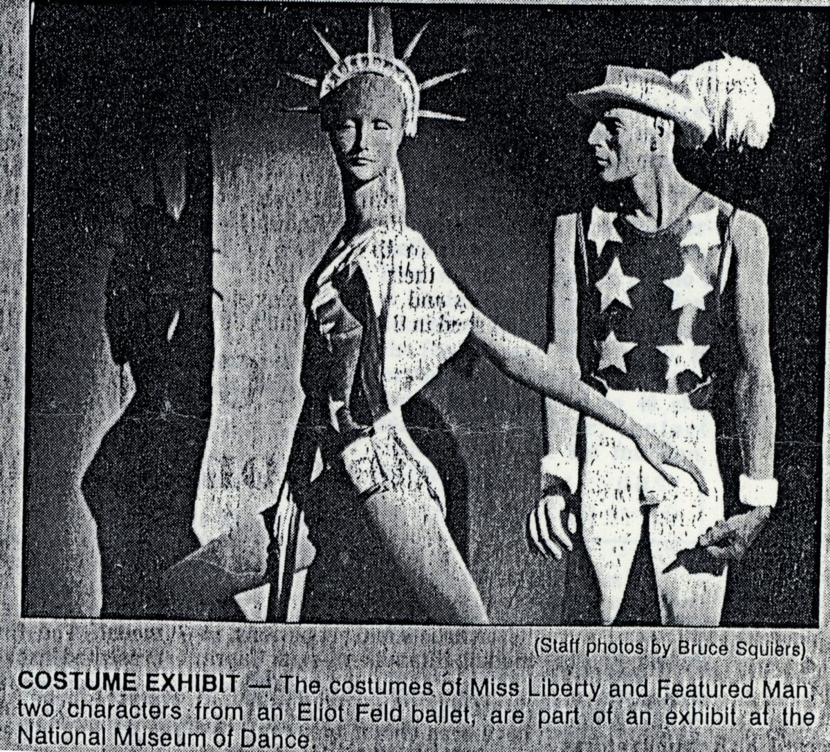 Scan of a newspaper clipping with a photo of the costume exhibit for Miss Liberty and Featured Man, two characters from Eliot Feld&#039;s &quot;Half Time.&quot;